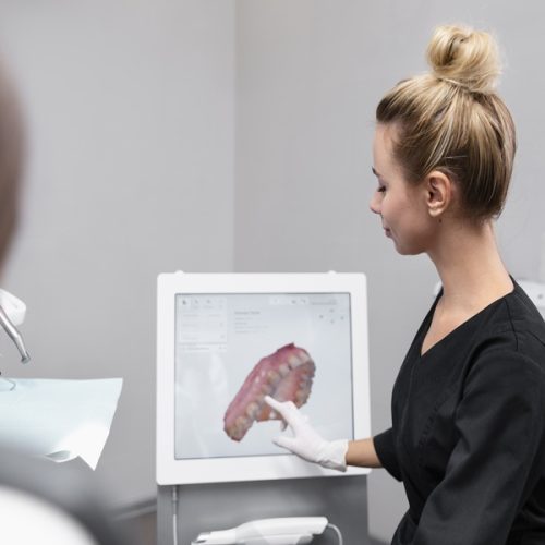 Dentist using digital scanner to capture 3D dental impressions at Dr. Panjiar’s Multispeciality Dental Centre, Hadapsar